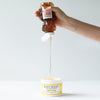 photo of honey being squeezed into sugar scrub